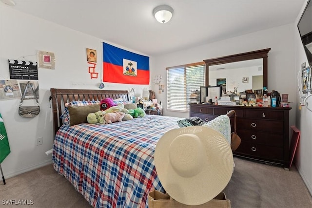 carpeted bedroom with baseboards