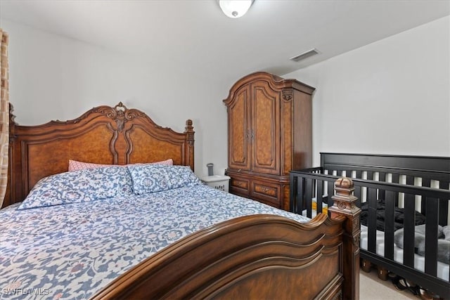 bedroom featuring carpet floors and visible vents