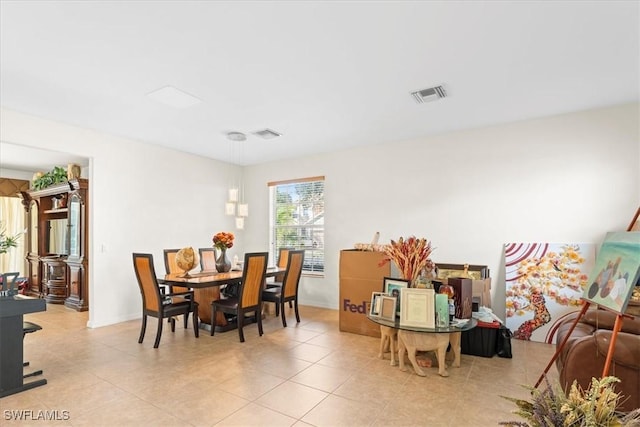 dining area with light tile patterned floors, baseboards, and visible vents