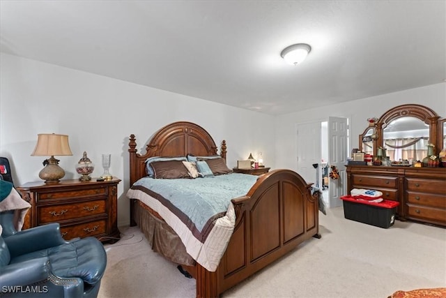 bedroom featuring light carpet