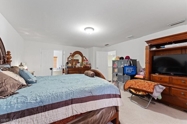 carpeted bedroom featuring visible vents