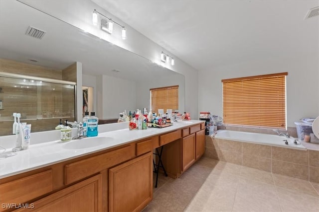 full bathroom featuring a garden tub, double vanity, visible vents, a sink, and a shower stall