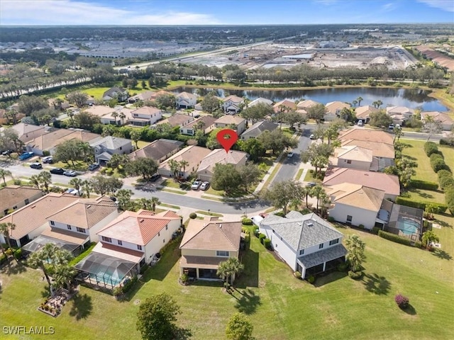 drone / aerial view featuring a residential view and a water view