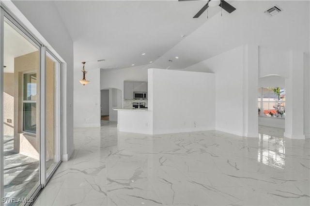 spare room with arched walkways, high vaulted ceiling, visible vents, a ceiling fan, and marble finish floor