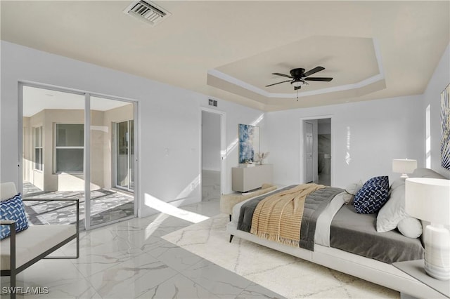 bedroom with marble finish floor, a raised ceiling, visible vents, and access to exterior