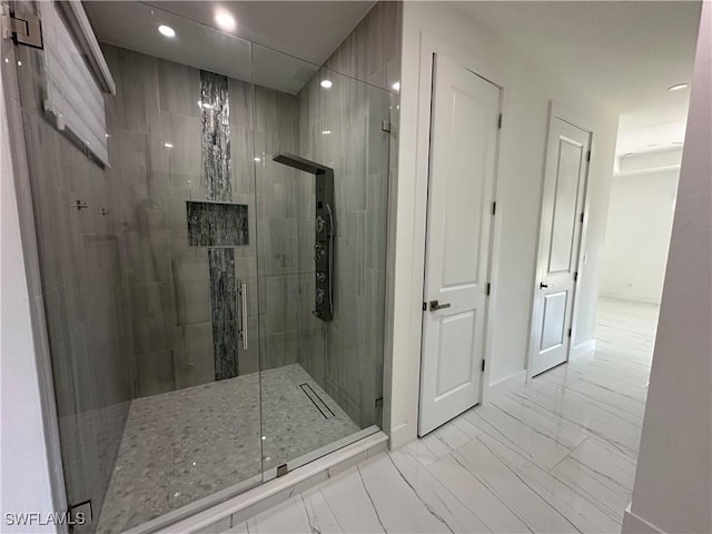 full bathroom featuring a stall shower, marble finish floor, baseboards, and recessed lighting