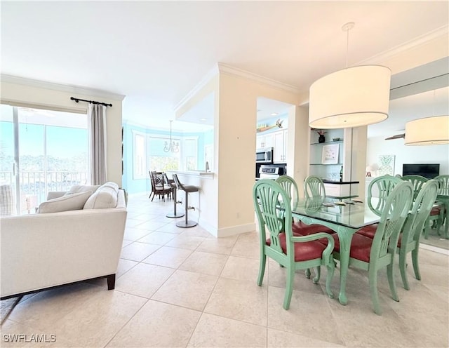 dining room with light tile patterned flooring, crown molding, and baseboards