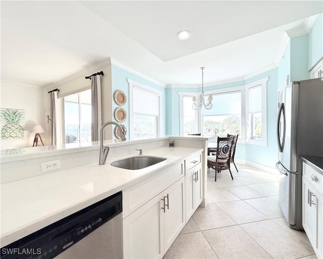 kitchen with light tile patterned floors, appliances with stainless steel finishes, decorative light fixtures, crown molding, and a sink