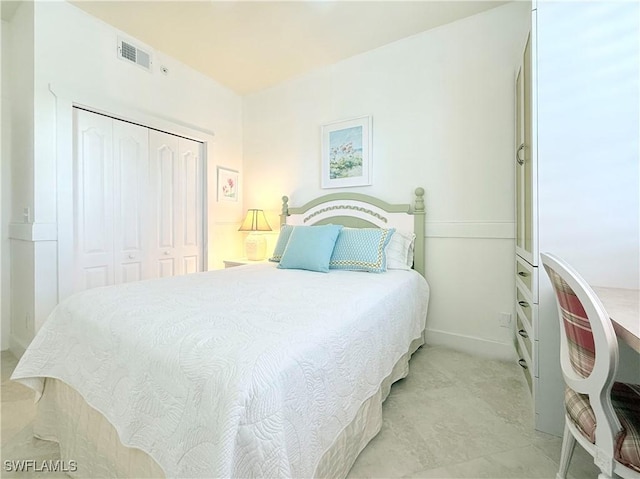 bedroom with a closet and visible vents