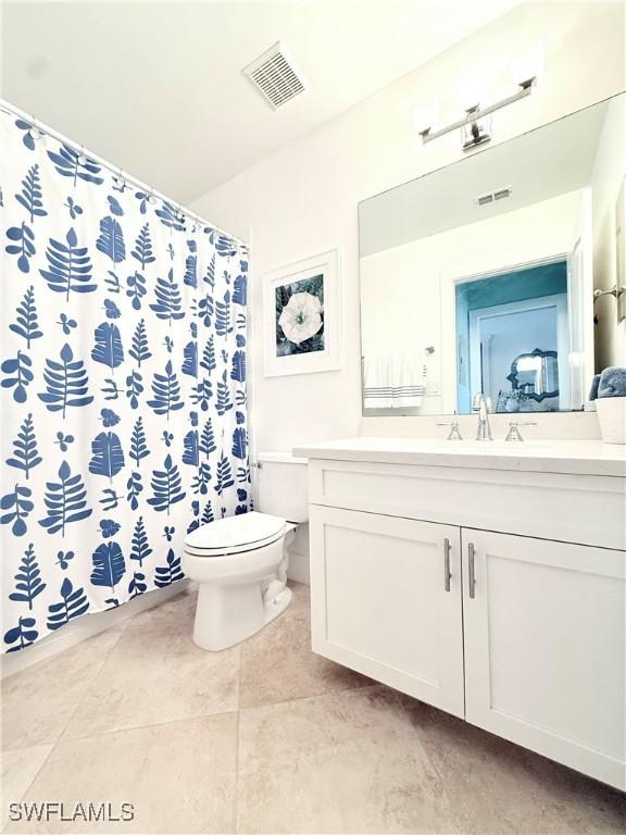 full bath featuring visible vents, a shower with shower curtain, toilet, tile patterned floors, and vanity