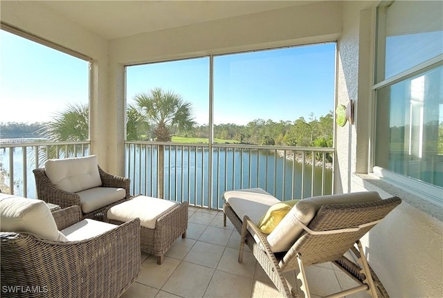 sunroom / solarium featuring a water view and plenty of natural light