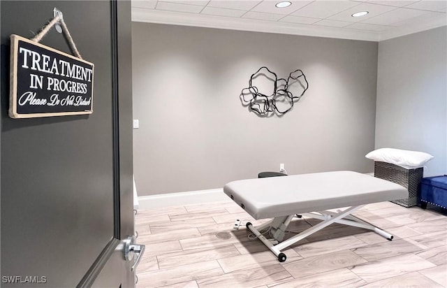 exercise room with wood tiled floor, crown molding, baseboards, and recessed lighting