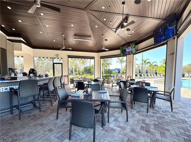 exterior space with a ceiling fan, outdoor dining area, an outdoor bar, and a gazebo