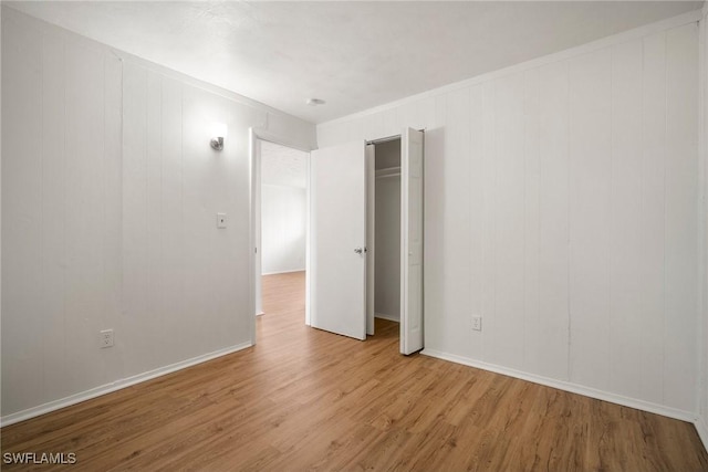 empty room featuring baseboards and wood finished floors