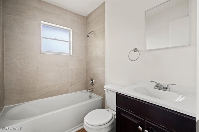 bathroom featuring toilet, vanity, and washtub / shower combination