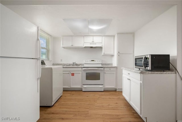 kitchen with white appliances, light wood finished floors, washer / clothes dryer, under cabinet range hood, and white cabinetry