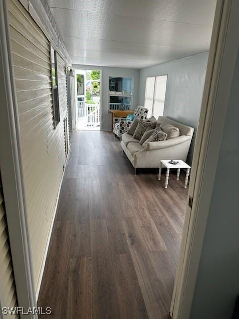 unfurnished living room with baseboards and wood finished floors