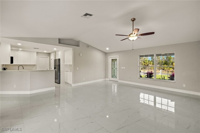 unfurnished living room featuring vaulted ceiling, marble finish floor, visible vents, and baseboards