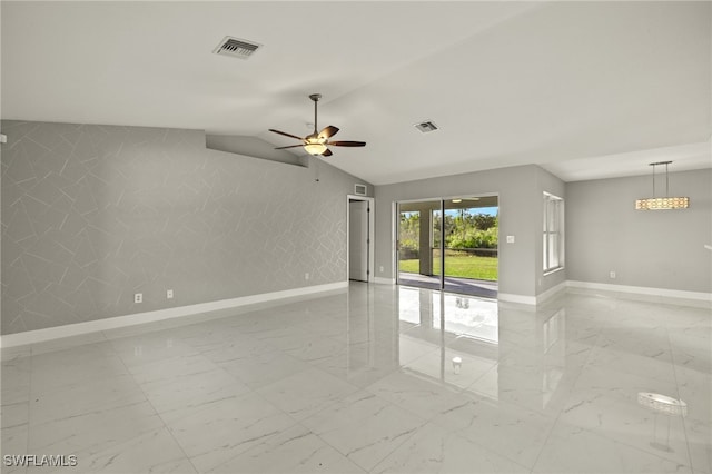 unfurnished room with marble finish floor, visible vents, ceiling fan, and baseboards