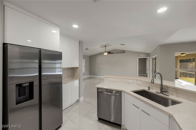 kitchen featuring white cabinets, marble finish floor, stainless steel appliances, and a sink