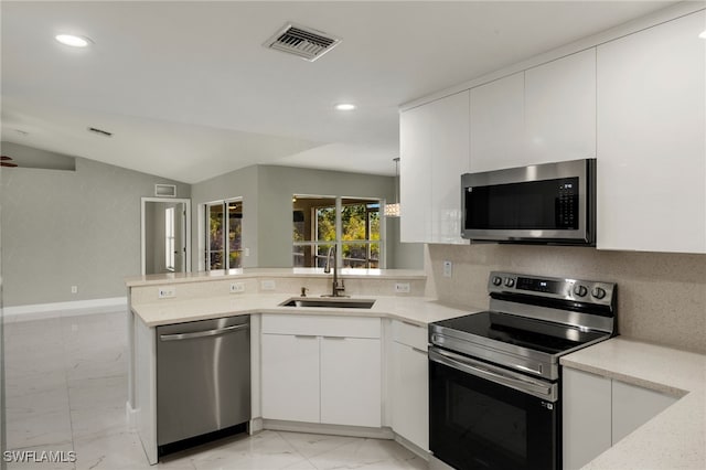 kitchen with visible vents, a peninsula, marble finish floor, stainless steel appliances, and a sink