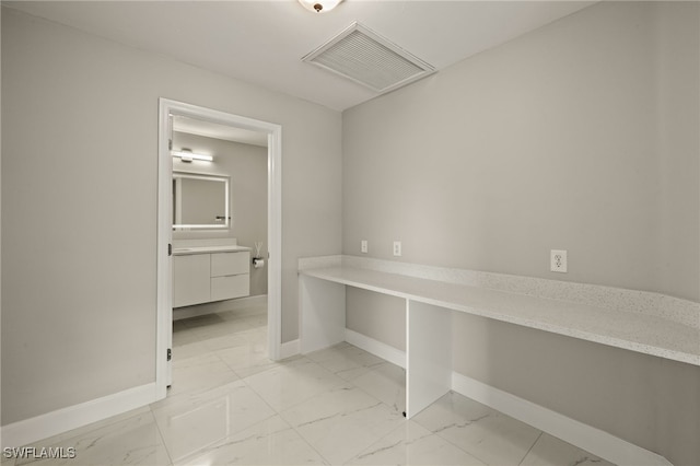 interior space with marble finish floor, baseboards, and visible vents