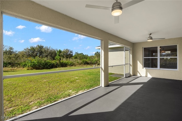 unfurnished sunroom featuring ceiling fan