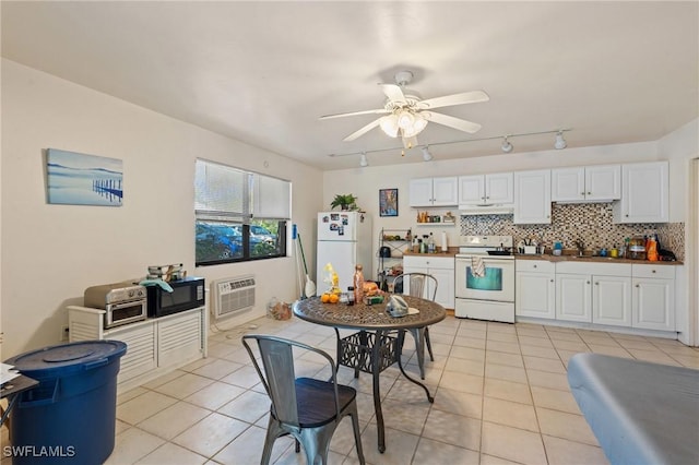 kitchen with white appliances, light tile patterned floors, backsplash, and an AC wall unit