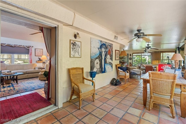 sunroom featuring a ceiling fan and visible vents