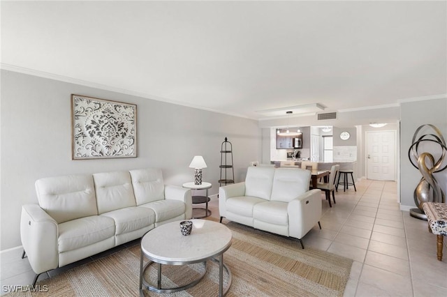 living area featuring visible vents, crown molding, baseboards, and light tile patterned floors