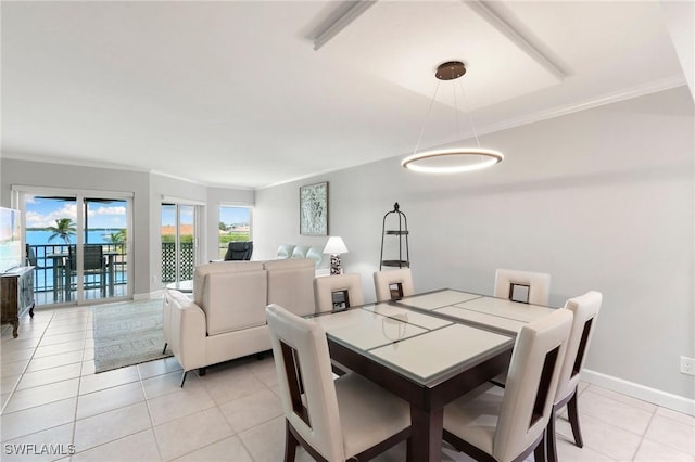 dining room with light tile patterned floors, baseboards, and ornamental molding