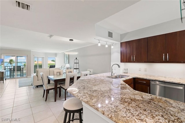 kitchen featuring a sink, visible vents, open floor plan, and stainless steel dishwasher