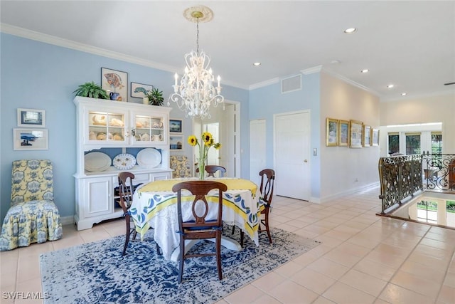 dining room with a chandelier, ornamental molding, light tile patterned flooring, and baseboards