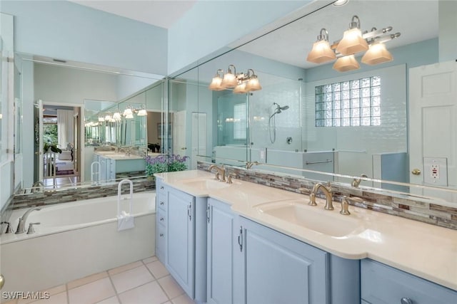 bathroom featuring a garden tub, double vanity, backsplash, and a sink