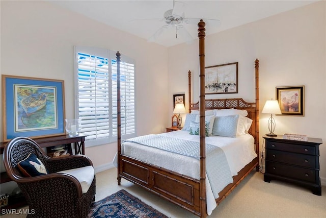 bedroom featuring light carpet, a ceiling fan, and baseboards