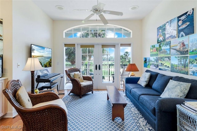 sunroom / solarium featuring ceiling fan and french doors