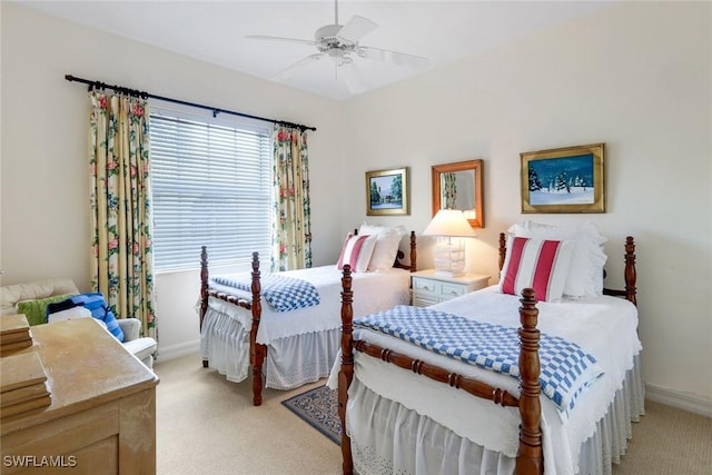 bedroom featuring ceiling fan, baseboards, and light colored carpet