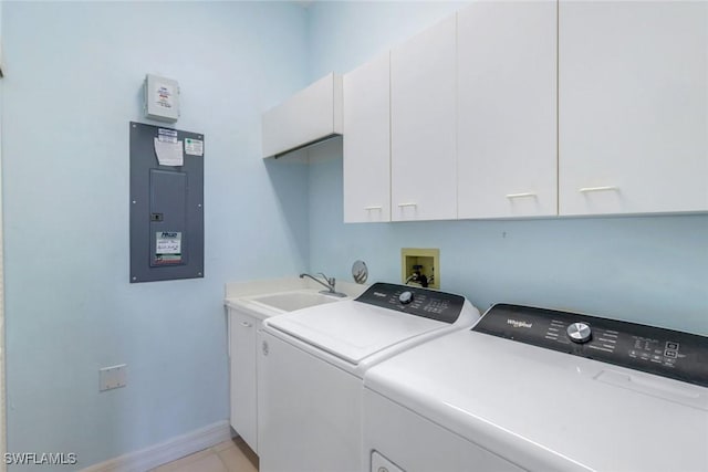 clothes washing area featuring cabinet space, a sink, separate washer and dryer, electric panel, and baseboards