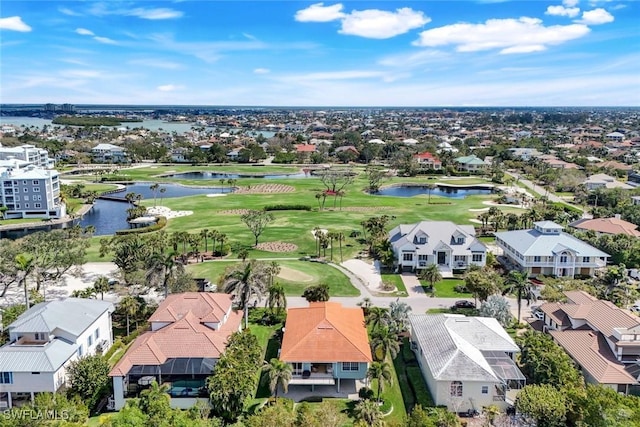 bird's eye view with golf course view, a water view, and a residential view