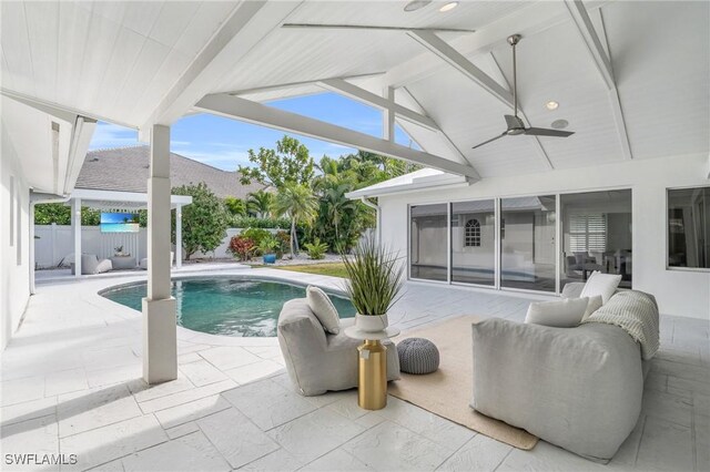 view of swimming pool with a ceiling fan, a fenced in pool, a patio, and fence