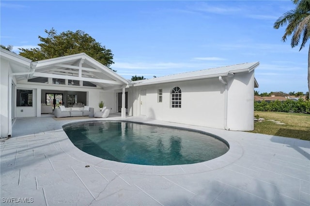 pool with outdoor lounge area and a patio area