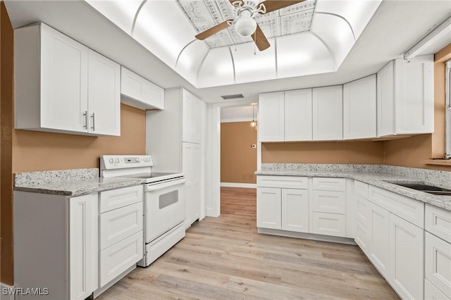 kitchen featuring a ceiling fan, white cabinetry, white electric stove, and light wood-style flooring