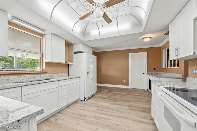 kitchen featuring white refrigerator with ice dispenser, range with electric cooktop, a raised ceiling, light wood-type flooring, and white cabinetry