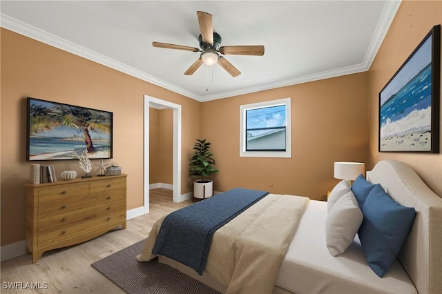 bedroom featuring light wood-style flooring, baseboards, ceiling fan, and crown molding