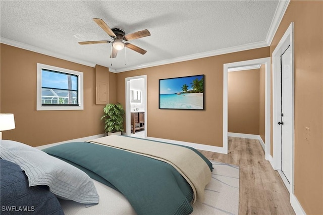 bedroom featuring ornamental molding, light wood finished floors, and a textured ceiling