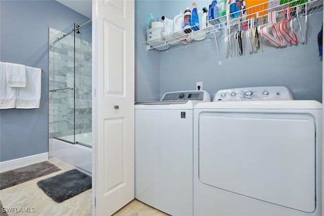 laundry area with washer and dryer, laundry area, and baseboards