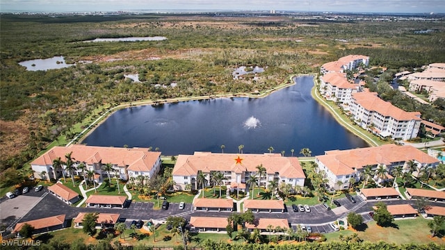 drone / aerial view with a water view and a residential view