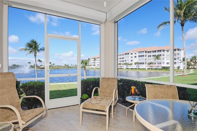 sunroom / solarium featuring a water view