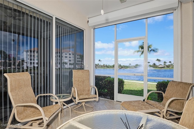 sunroom / solarium featuring a water view