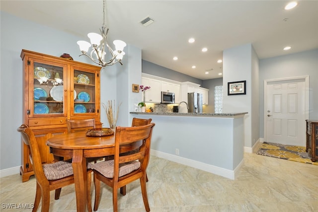 dining space with an inviting chandelier, recessed lighting, visible vents, and baseboards